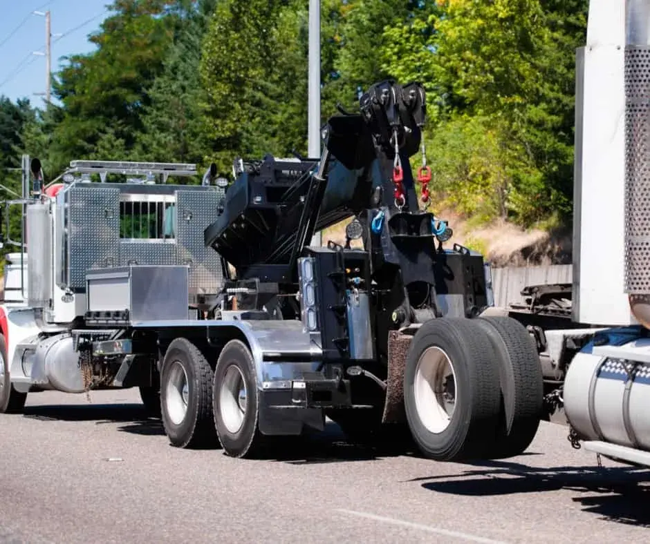 heavy-duty wrecker on a Leduc highway shoulder