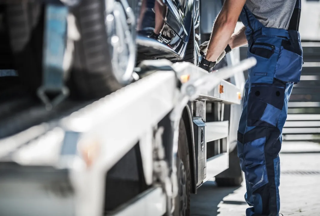 Edmonton tow truck driver loading a car onto a flatbed